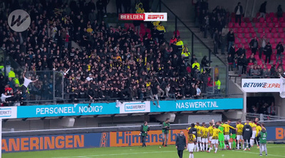 a group of people standing on top of a soccer field