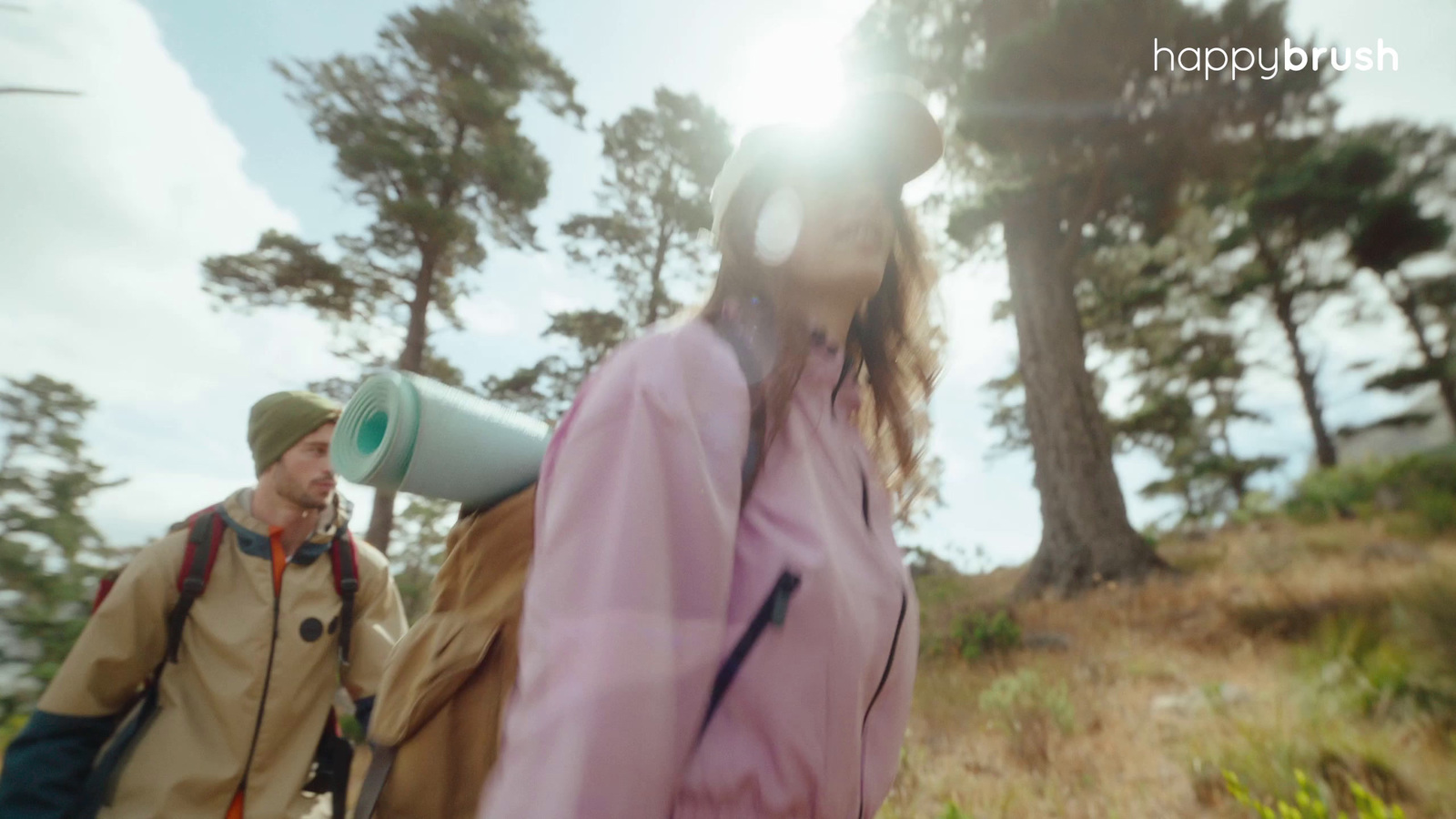 a man and a woman walking through a forest