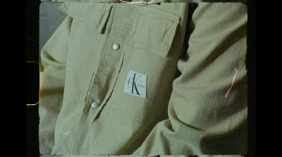 a person wearing khaki pants with a name tag on it