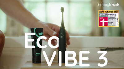 a person holding an electric toothbrush next to a tube of deodorant