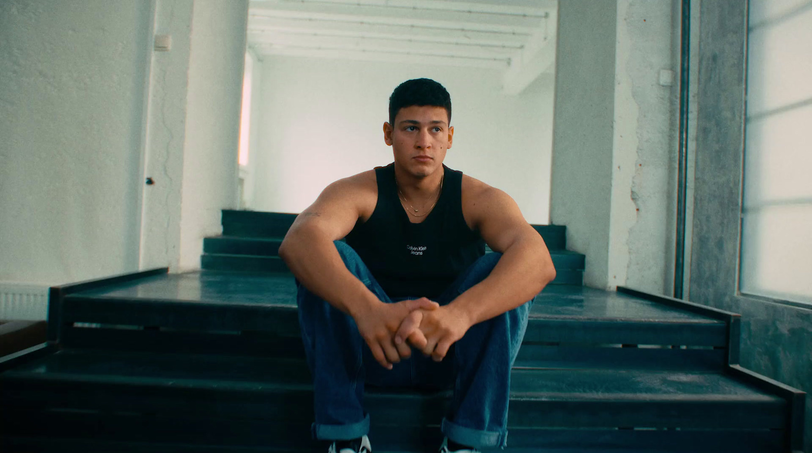 a young man sitting on a set of stairs