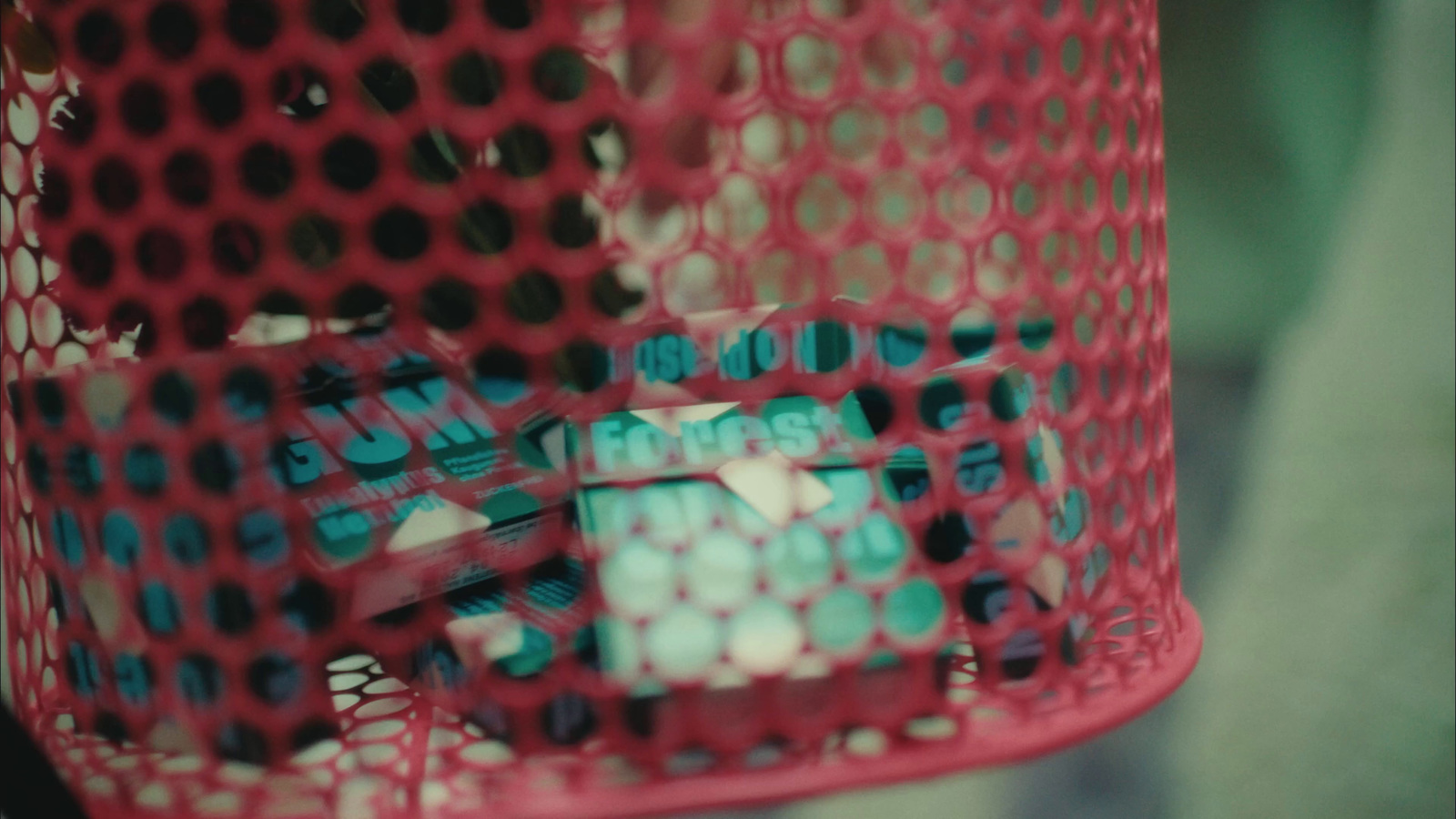 a close up of a red mesh container filled with pills