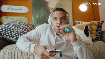 a man sitting on a couch holding a video game controller