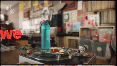 a blue water bottle sitting on top of a record player