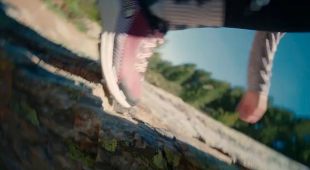 a person walking up a hill on a skateboard