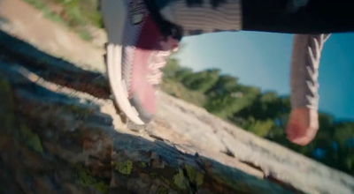 a person standing on a rock with their feet up