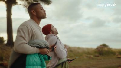 a man and a woman walking down a dirt road