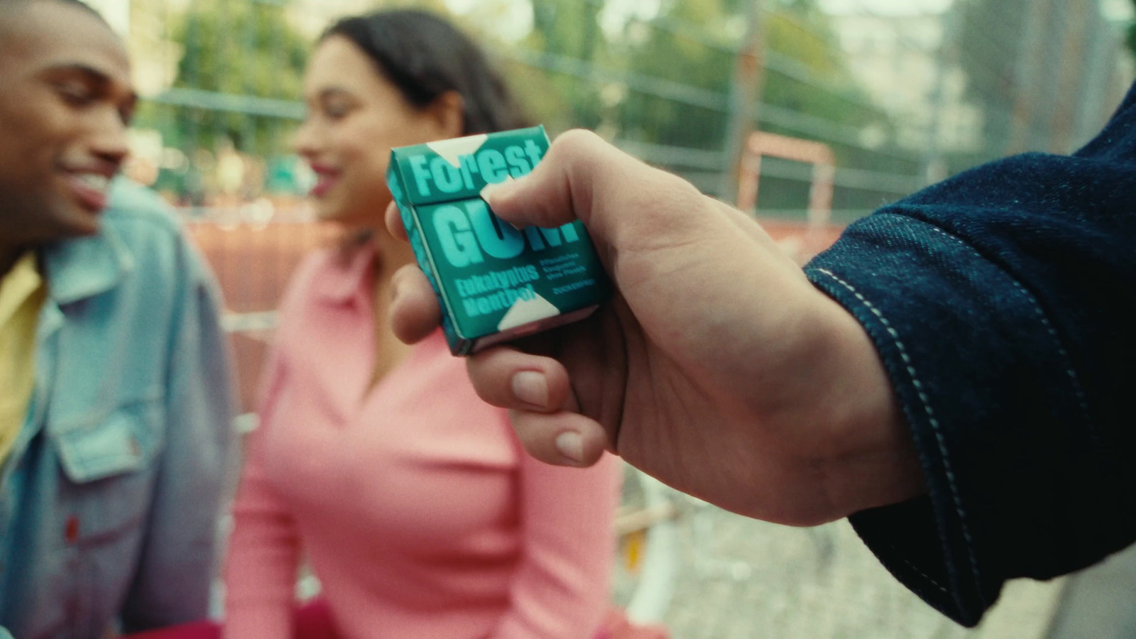 a man holding a small green object in his hand