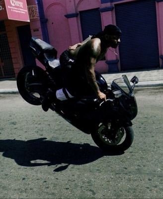 a man riding on the back of a motorcycle