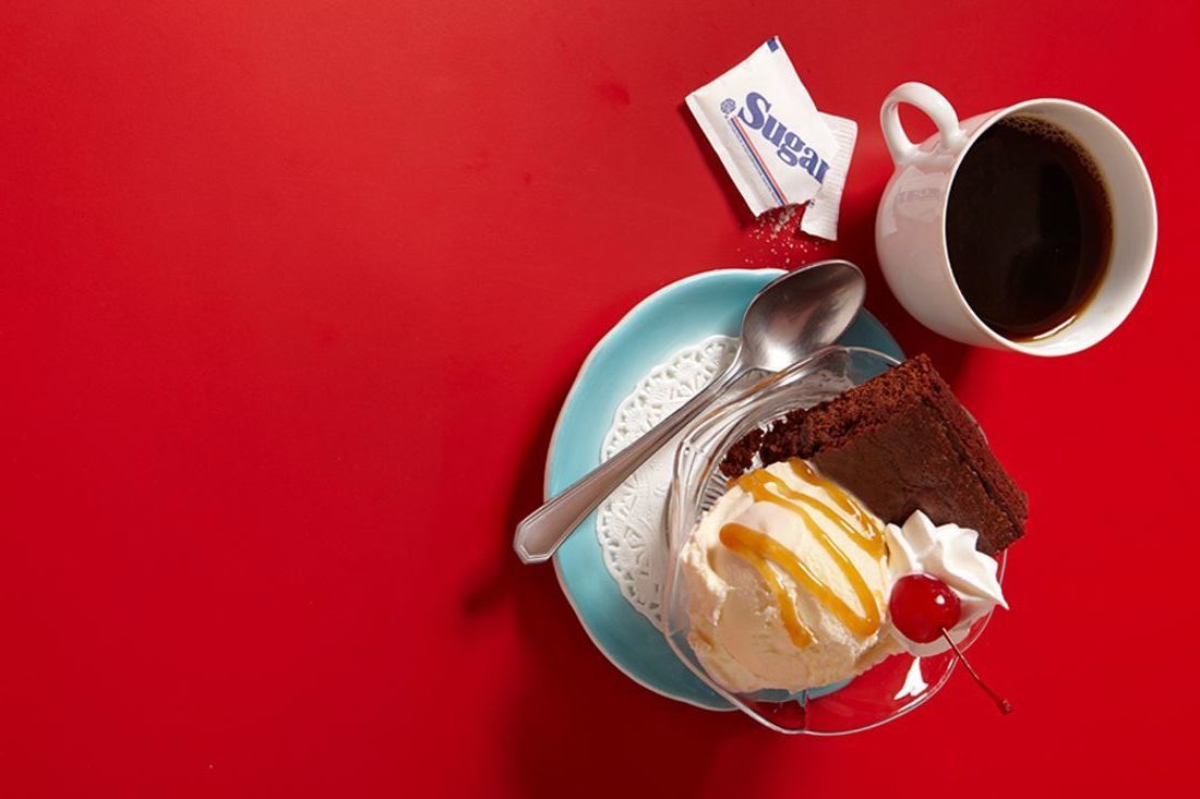 a plate with a piece of cake and a cup of coffee