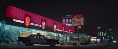 a truck parked in front of a store at night