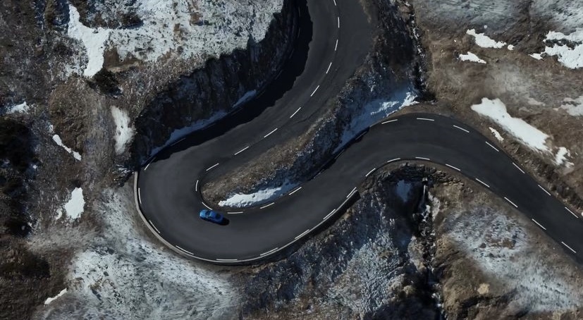 an aerial view of a winding road in the mountains