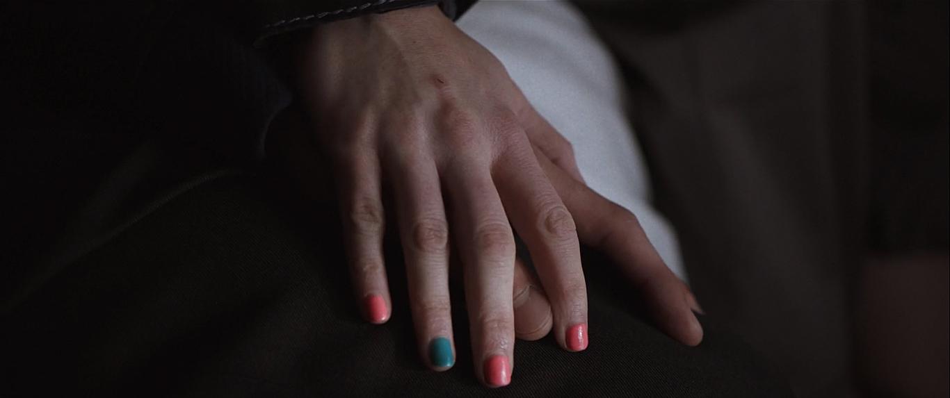 a woman's hand with multicolored nails