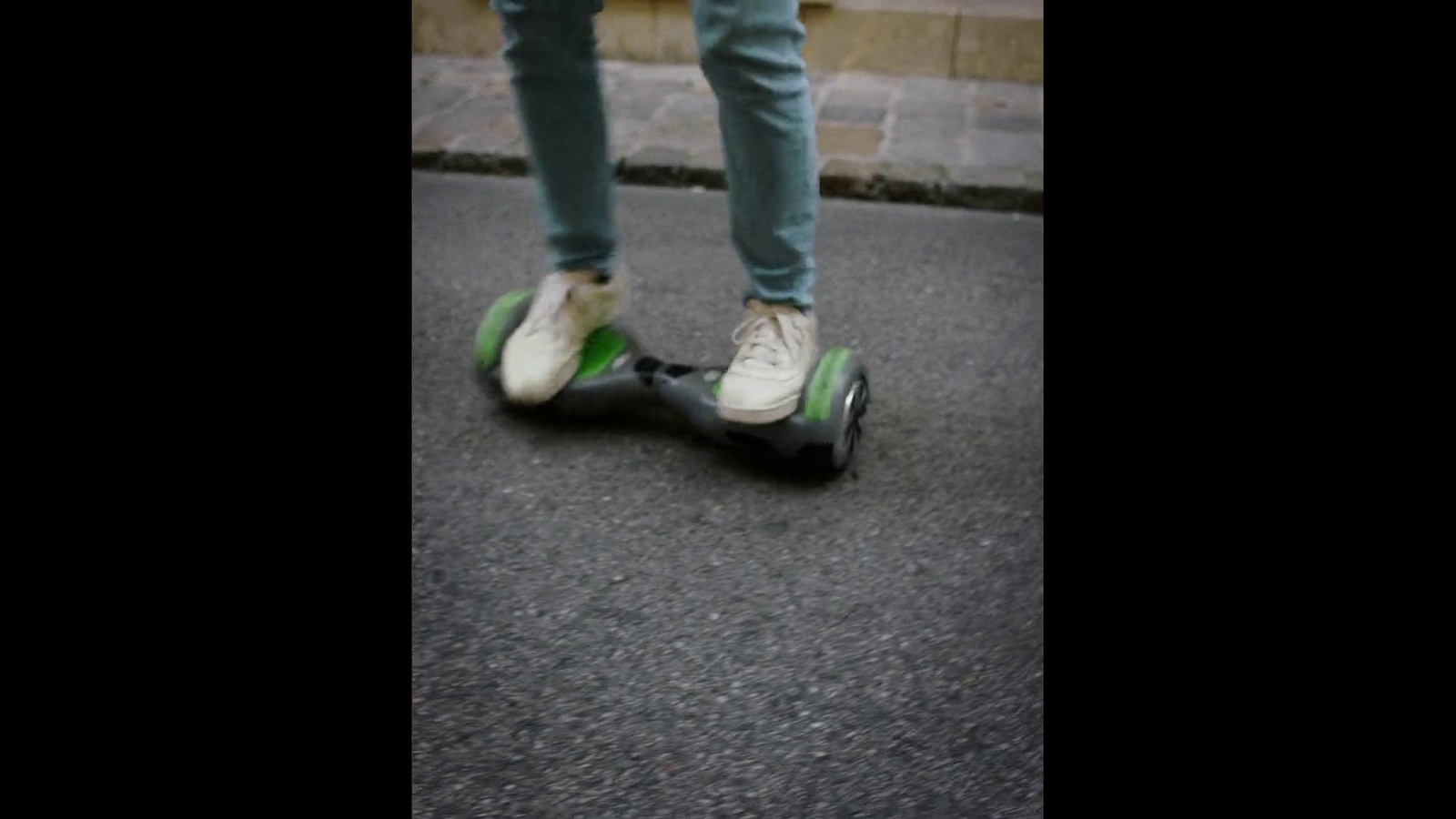 a person riding a skateboard down a street