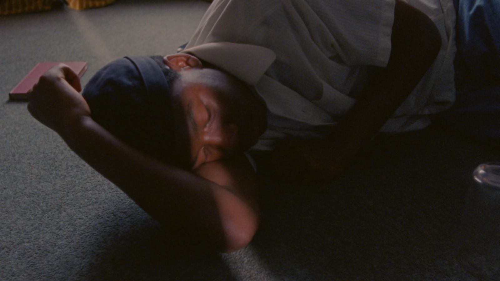 a man laying on the floor with his head on a skateboard