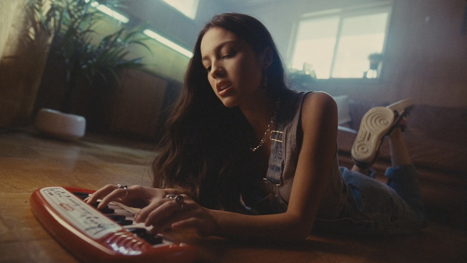 a woman sitting on the floor using a keyboard