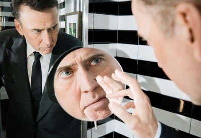 a man looking at himself in the mirror