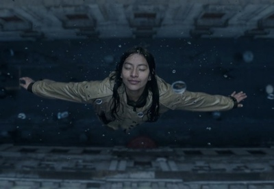 a woman floating in the air with her arms outstretched