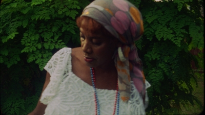 a woman wearing a white top and a multicolored scarf