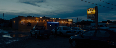 a group of cars parked in front of a building