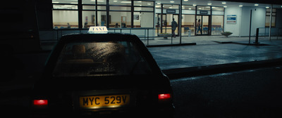 a car parked in front of a building at night