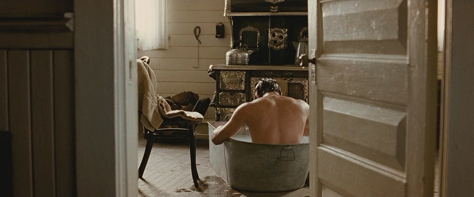 a man sitting in a tub in a room