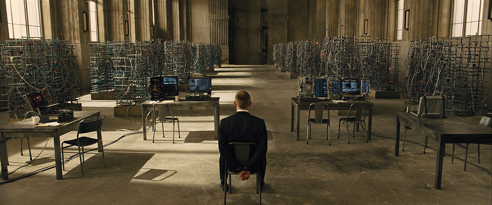 a man standing in a room filled with desks and computers