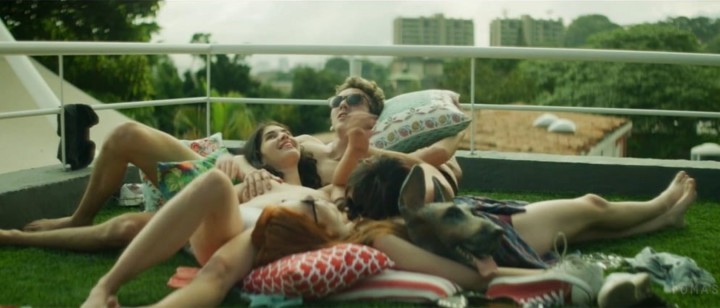 a group of people laying on top of a lush green field