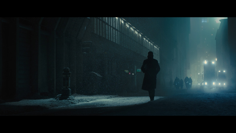 a man walking down a street at night