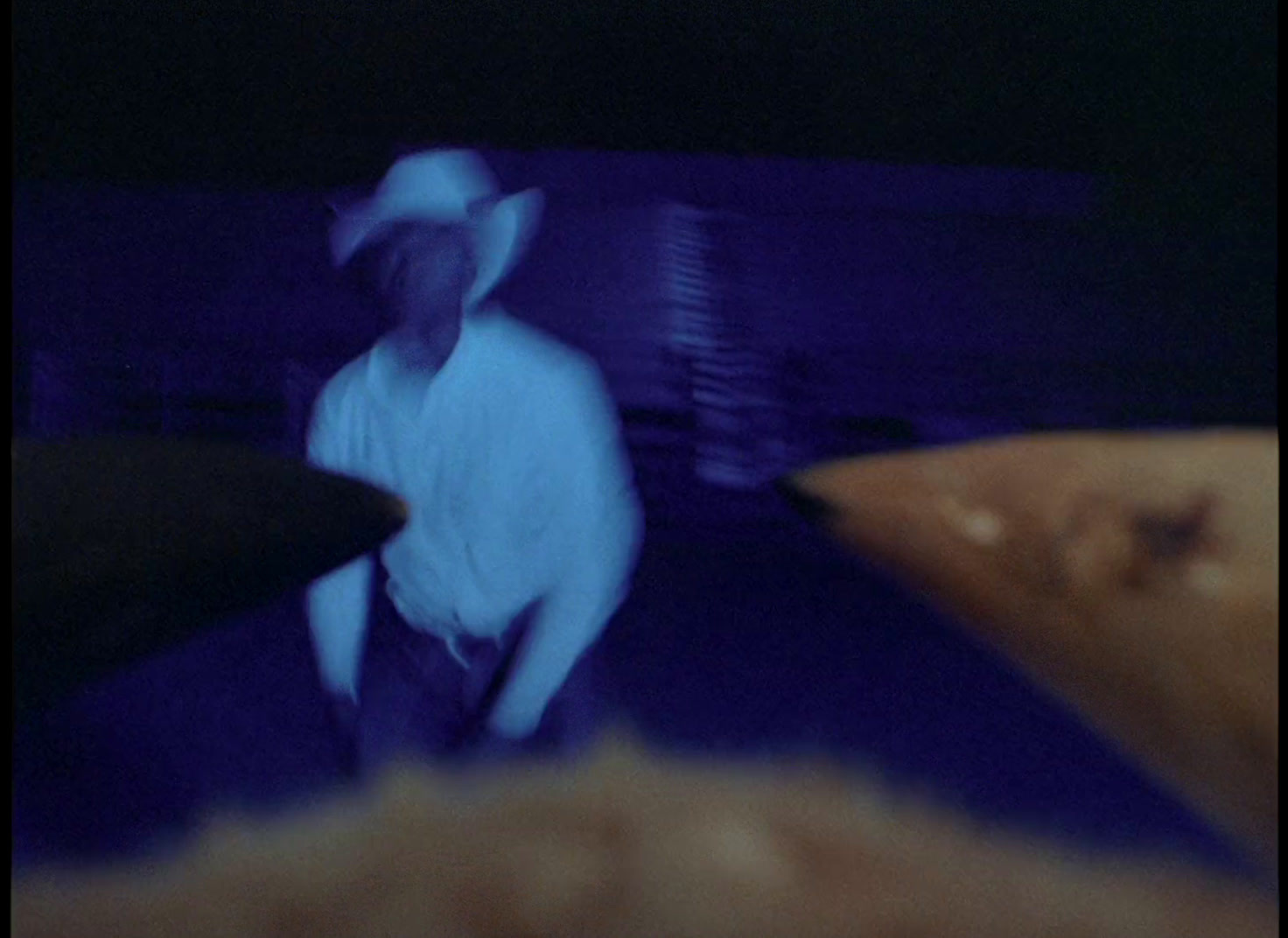 a blurry image of a man in a hat