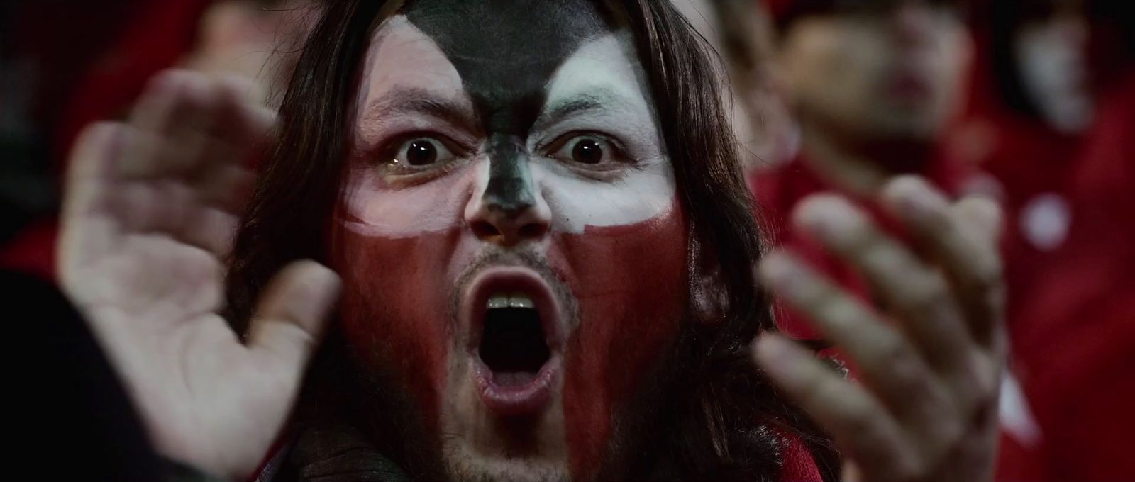 a man with his face painted red and white