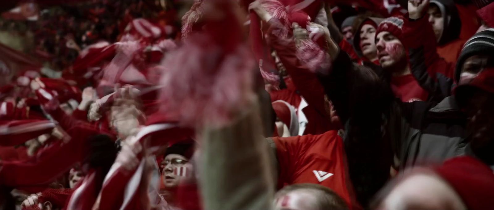 a large group of people with red and white shirts