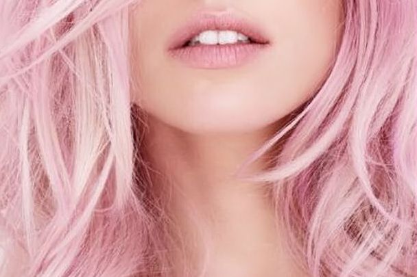 a close up of a woman with pink hair