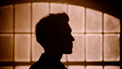 a silhouette of a man in front of a window