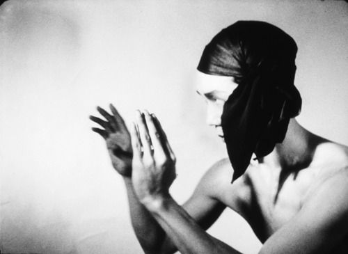 a black and white photo of a woman holding her hands together