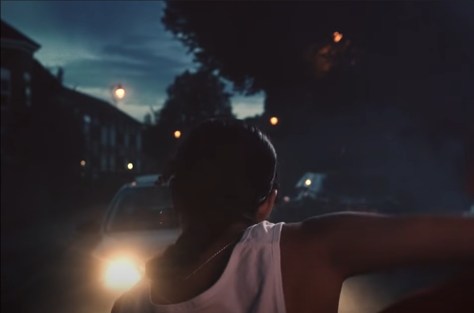 a man standing next to a car at night