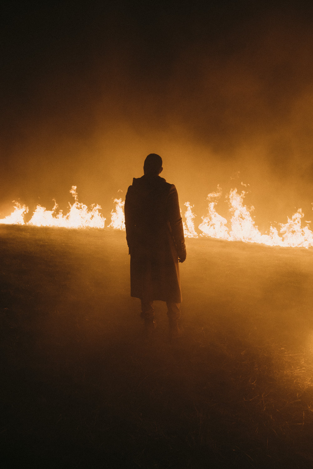 a person standing in front of a fire