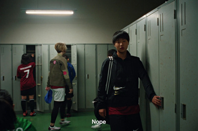 a man standing in a locker room next to lockers