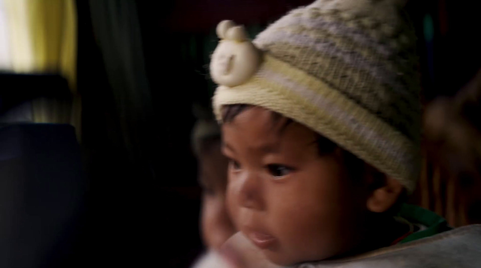 a small child wearing a knitted hat