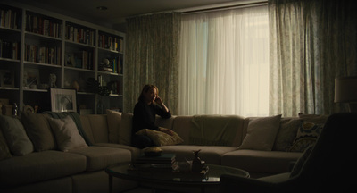 a woman sitting on a couch in a living room