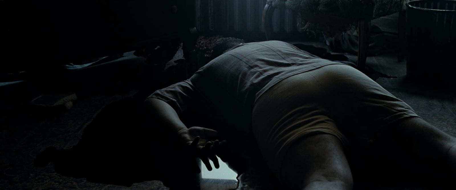 a person laying on the floor in a dark room