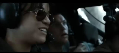 a couple of people sitting in a plane with headphones