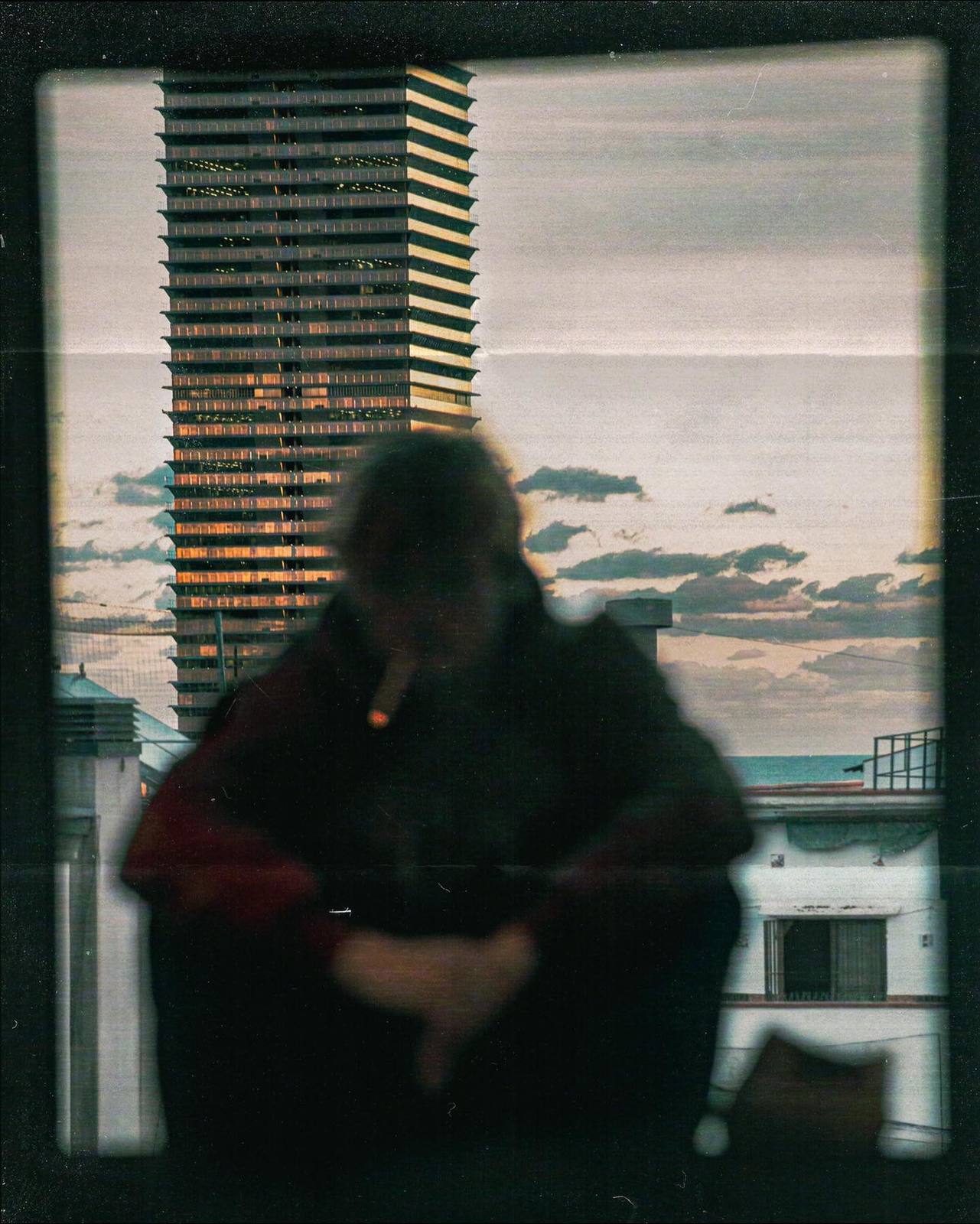 a man sitting in a chair in front of a window