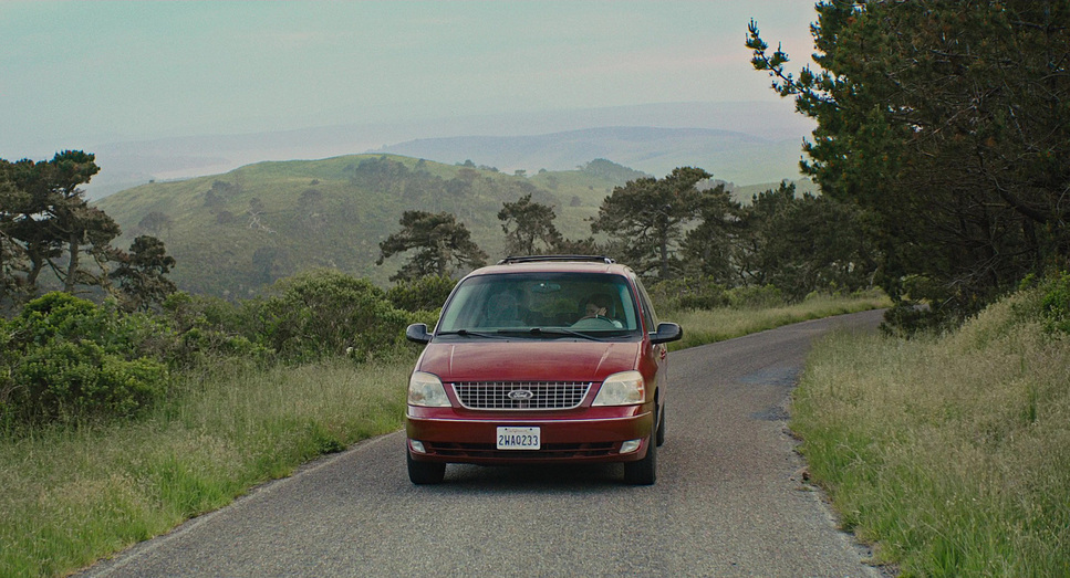 a red car parked on the side of a road