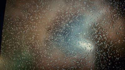 a close up of a window with rain drops on it