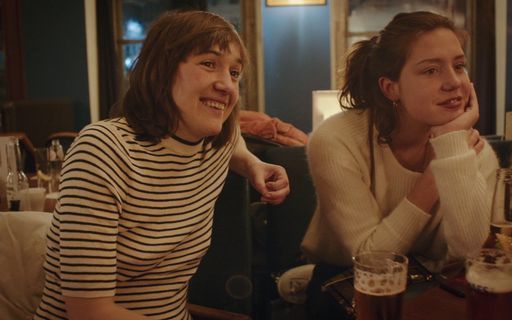 a couple of women sitting next to each other