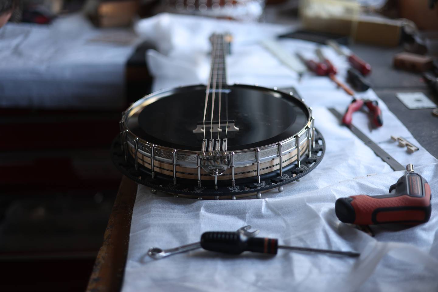 a guitar sitting on top of a table next to tools