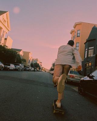 a man riding a skateboard down a street