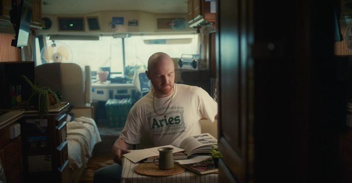 a man sitting at a table reading a book