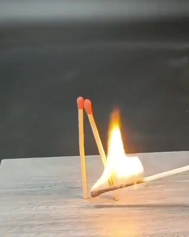 a pair of matchsticks hitting a match on a table